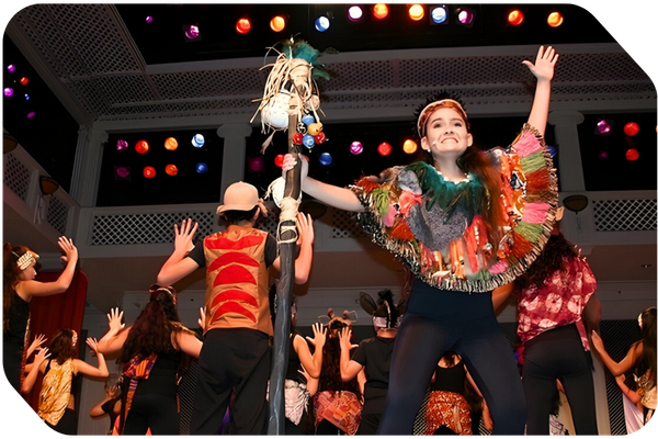 high school students in costume performing the lion king musical onstage