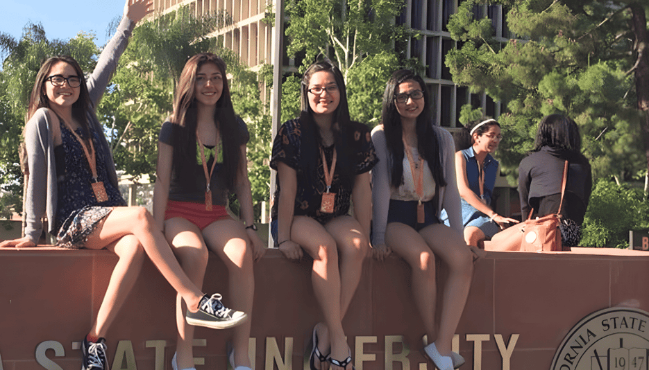 trio tour group at college entrance